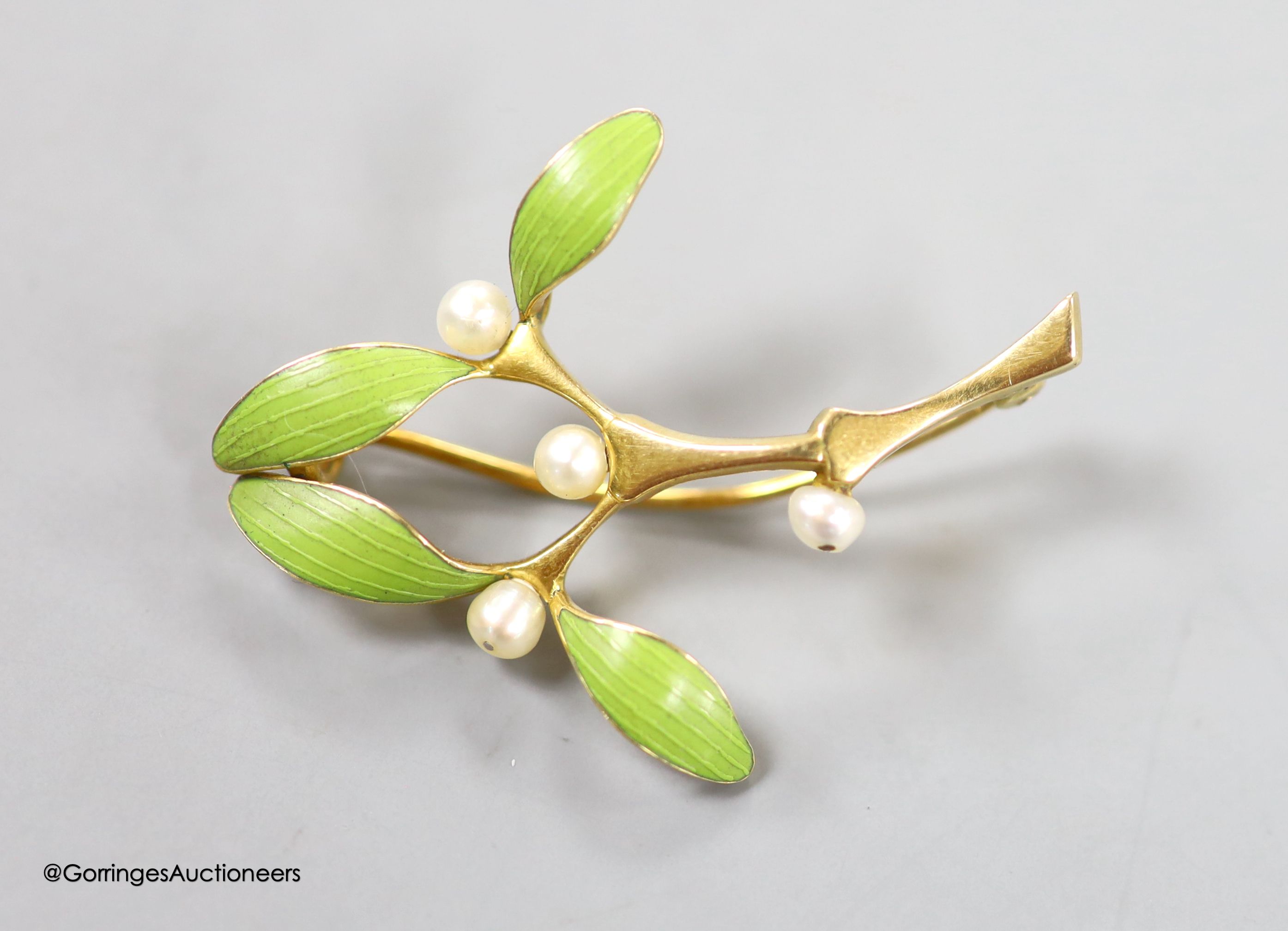 An Art Nouveau yellow metal, green enamel and seed pearl set foliate brooch, 38mm, gross weight 5.2 grams.